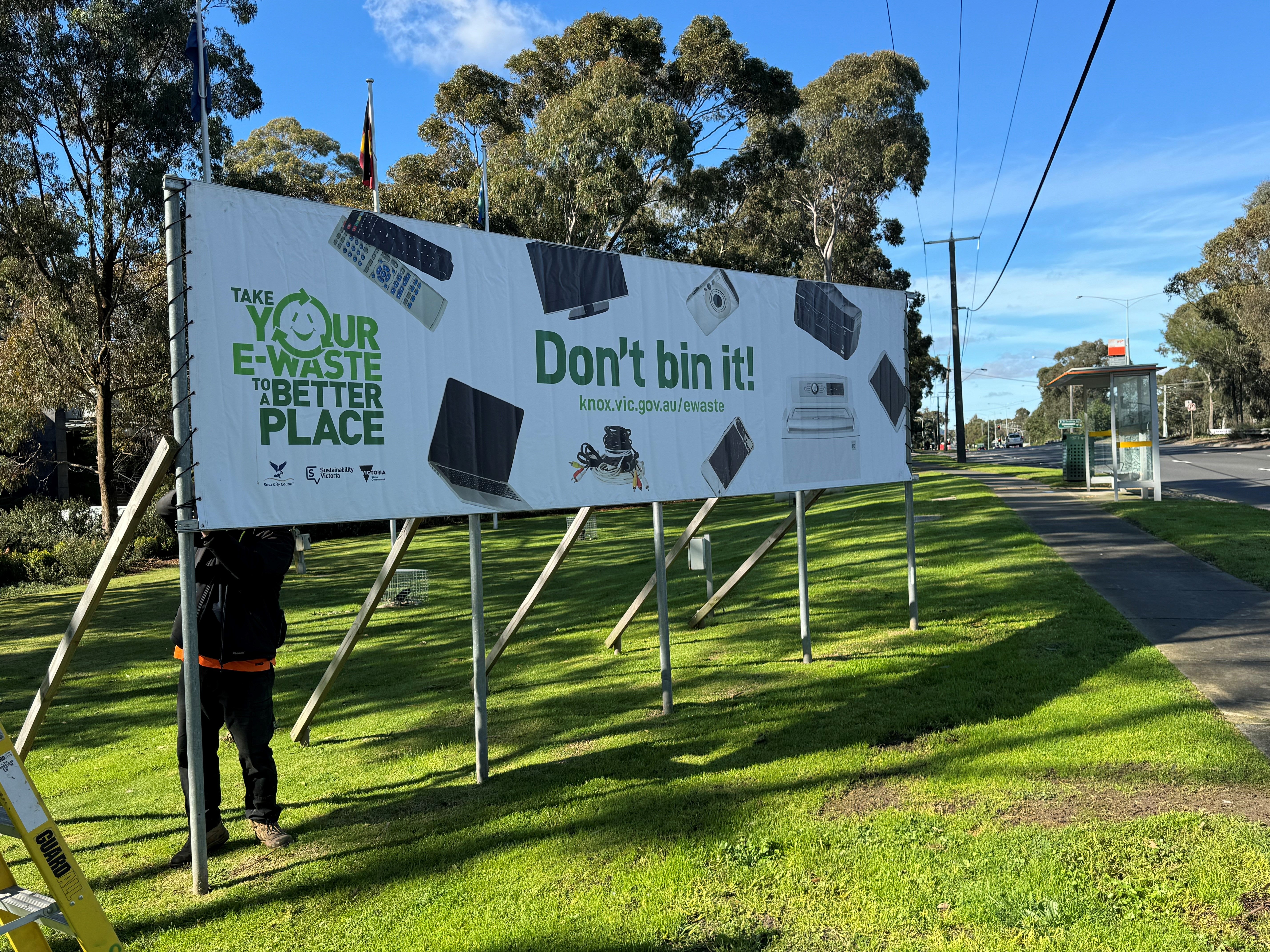 freestanding banner on grass with recycling message for a Council being installed
