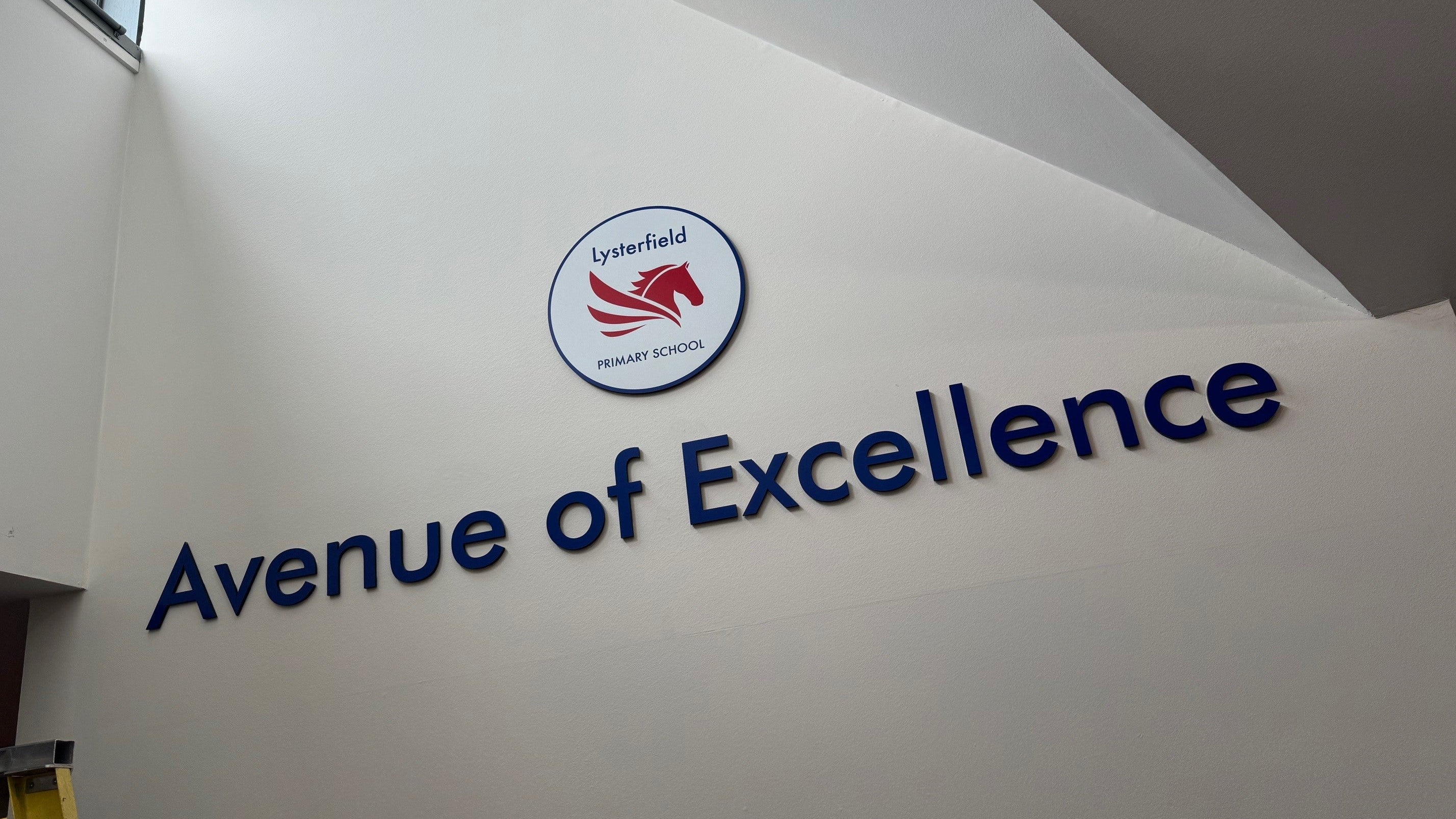 School wall with Avenue of Excellence 3D acrylic sign in reception foyer